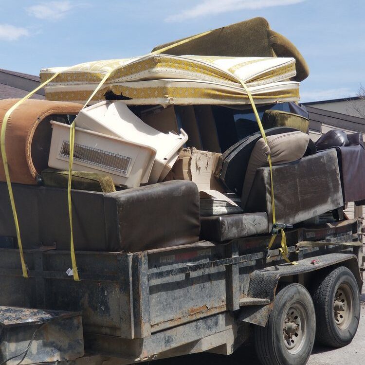 Trailer loaded with discarded furniture and mattresses
