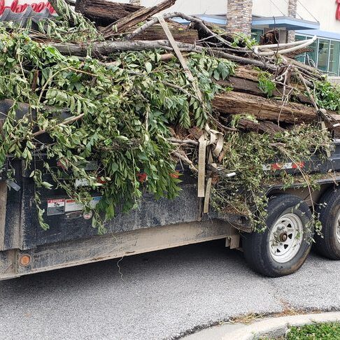 Trailer piled with tree branches and yard debris