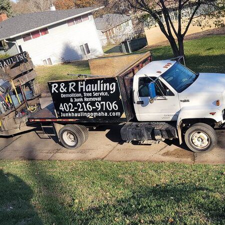 R&R Hauling white truck and trailer parked